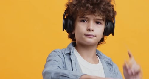 Child with Headphones Dancing to Music
