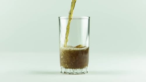 Soda Being Poured Into Glass Cup Indoors