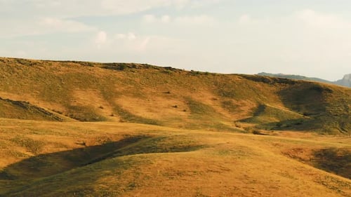 Rolling Hills and Mountainous Landscape