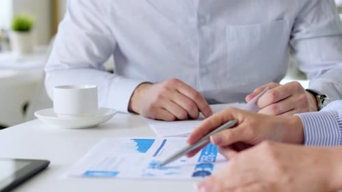 Business Team with Charts at Office Meeting