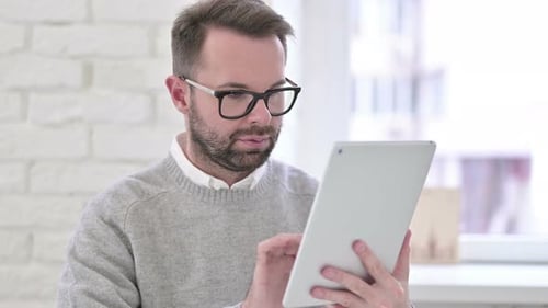 Creative Young Designer Using Tablet in Modern Office