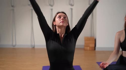 Athletic woman doing yoga for health. The girl is in the lotus position and folds her hands Namaste