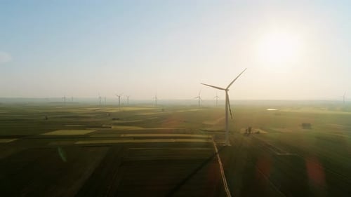 Drone view of wind generators on sunny morning