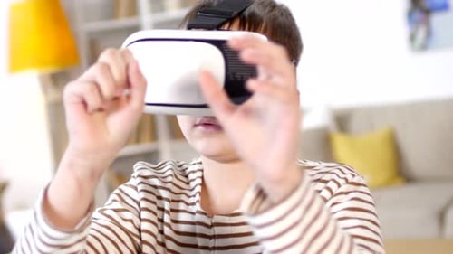 Boy Immersed in Virtual Reality at Home