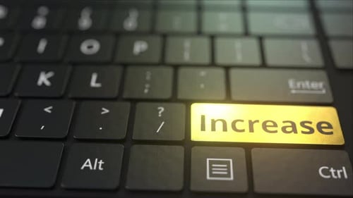 Clavier d'ordinateur noir et touche d'augmentation dorée