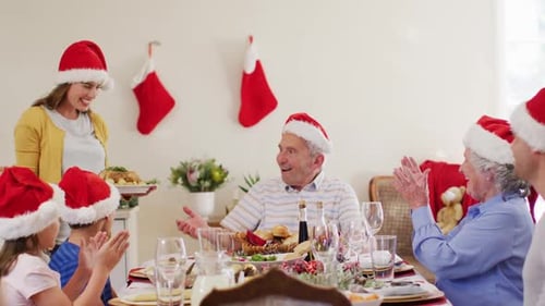 Family Christmas Celebration with Food and Santa Hats