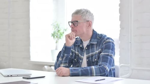 Thoughtful Casual Middle Aged Man Thinking in Office