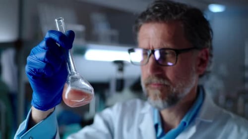 Scientist Examining Liquid in Lab Flask