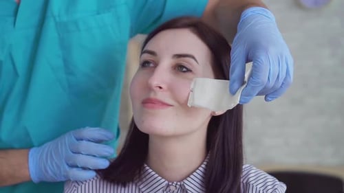 Woman Receiving Medical Care in Clinic Close Up
