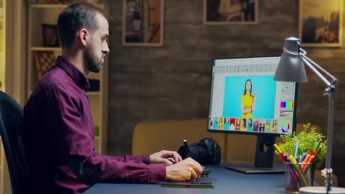 Man Edits Photo on Graphic Tablet and Computer