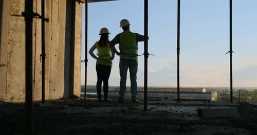 Construction Business Teamwork Concept Young Engineer Standing Behind Looking at a Building Site