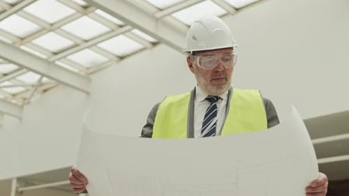 Foreman Looking Carefully at Project Paper