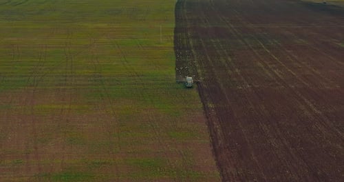 Aerial View of Agricultural Field in Sowing Season Tractor is Seeding Wheat Prores