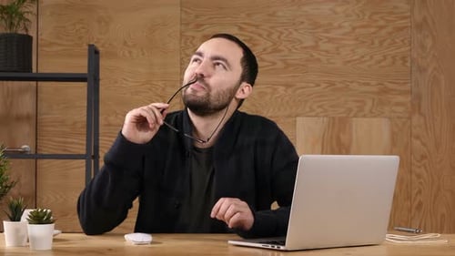 Man Thinking with Computer in Office Workplace
