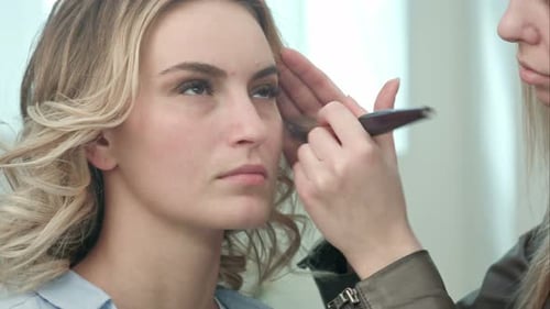 Makeup Artist Applying Makeup to Woman's Face