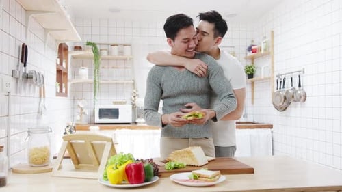 Affectionate Couple Makes a Sandwich Together at Home