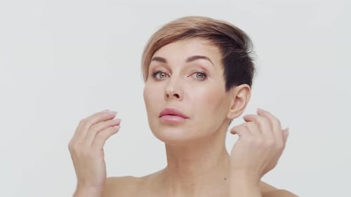 Close-up of middle aged mature woman over white background.