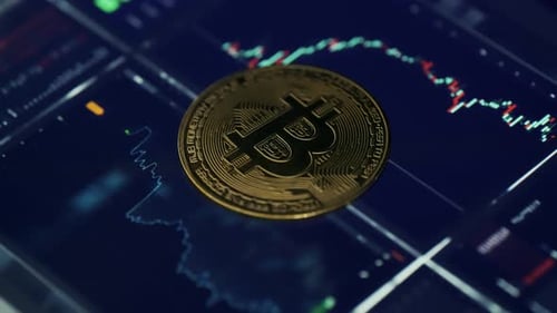 Close Up of Bitcoin Over Stock Market Data