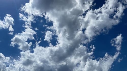Clouds Drifting in a Vivid Blue Sky