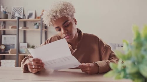 Woman Reads Letter and Celebrates Good News