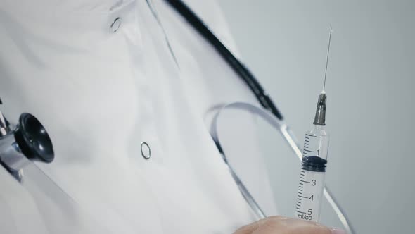 Closeup of liquid sprinkles from needle of syringe, Medical Stock ...