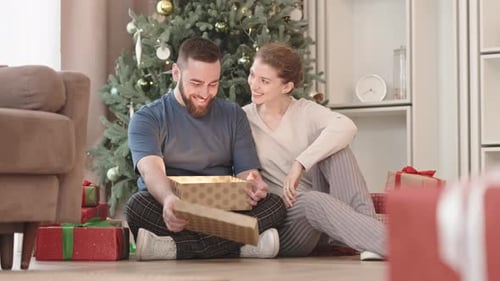 Couple Opening a Magical Christmas Gift Together
