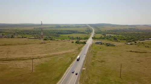 Truck Travels Through Rural Countryside on Sunny Day