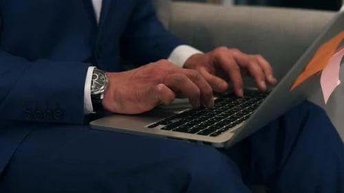 Close Up of Man Typing on Laptop Indoors