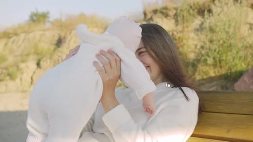 Loving Mother Embracing her Infant Child Outdoors