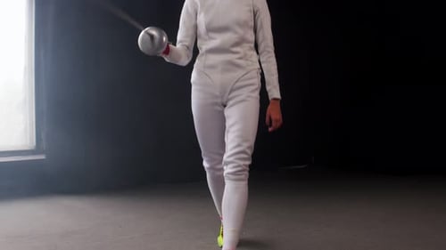 A Young Woman Fencer Walking To the Fighting Area and Starts the Duel