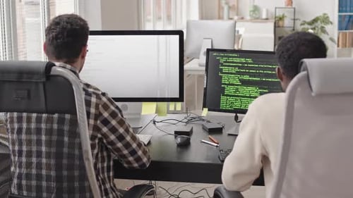 Rear-View of Programmers at Workplace