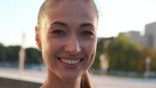 Woman Smiling Close Up in Urban Setting