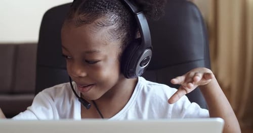 Portrait of Afro American Kid Girl School Pupil Wearing Headphones Studying Online Distant From Home