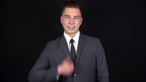 Young Man in Suit Gives Thumbs Up