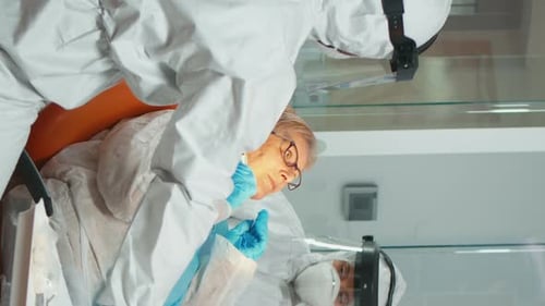 Medical Team Treating Patient in Full Protective Gear