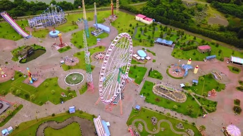 Top view of amusement park with Ferris wheel and roller coaster