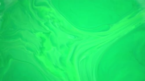 Ink in Water. Green Ink Reacting in Water Creating Abstract Background