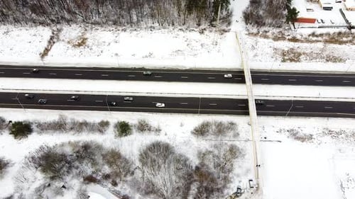 Vehicles speeding through A1 highway in Lithuania, winter season. Aerial view