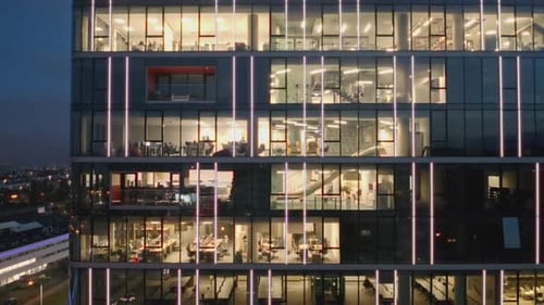Aerial View of the Night Windows of Offices in a Modern Skyscrape