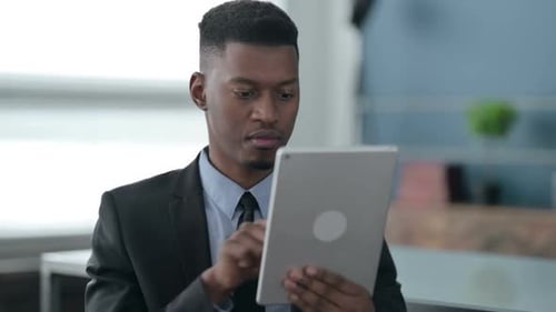 Portrait of African Businessman using Tablet in Office
