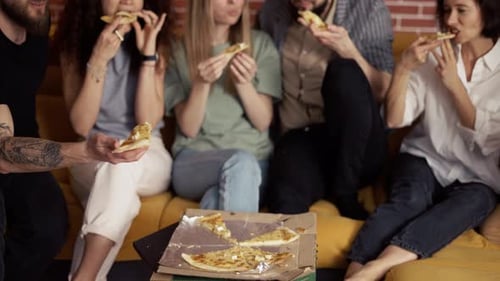 Male and Female Hands Taking Slices of Pizza From Food Delivery