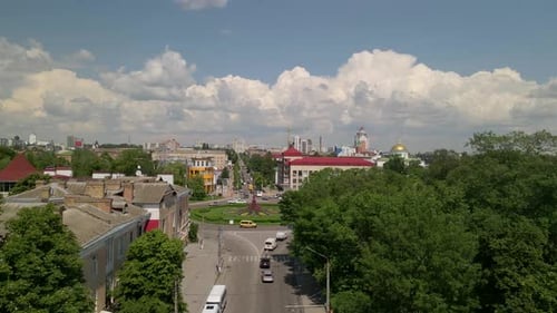 Aerial View of Roundabout Road with Circular Cars in Small European City at Sunny Day