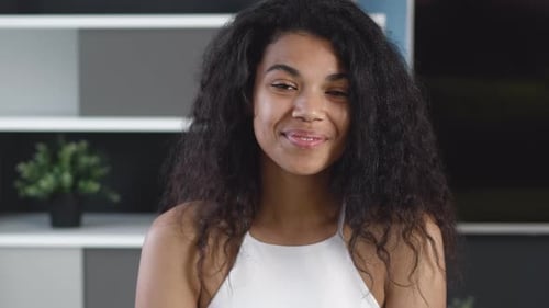 Smiling young woman looking at the camera