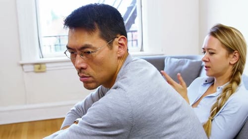 Troubled Couple Talking Indoors at Home