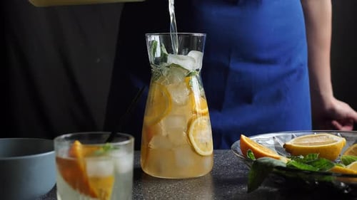 Pouring Lemonade in a Pitcher Full of Ice