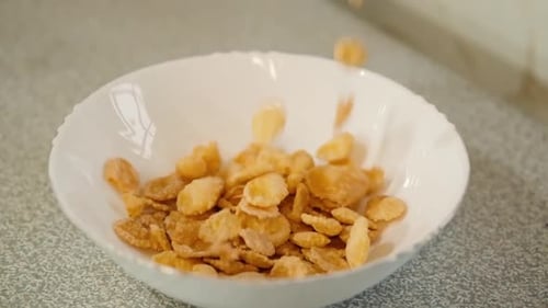 Cornflakes Cereal Being Poured Into Bowl