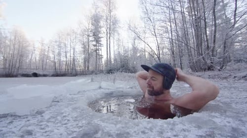 Man Takes Ice Bath in Frozen Lake