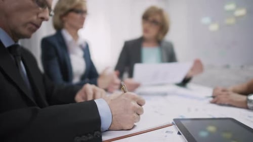 Verkaufsleiter schreibt während des Brainstorming-Meetings im Notizbuch, Arbeitsprozess