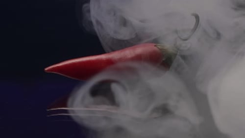 Red Chili Pepper with Smoke on Reflective Surface
