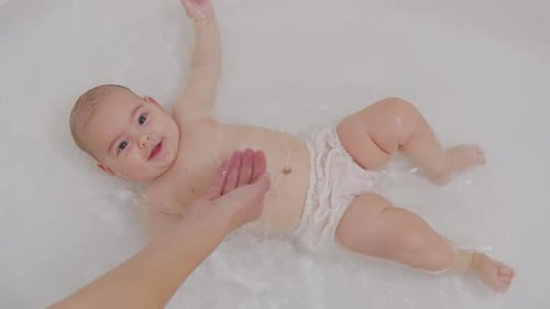 Top View Funny Newborn Baby Swimming During Bathing